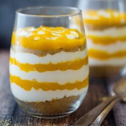 Layered Mango Cheesecake Parfait in a glass.