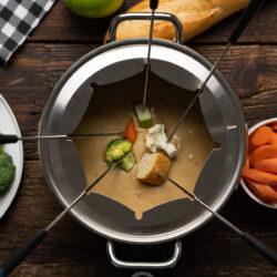 A fondue pot filled with beer cheese fondue.