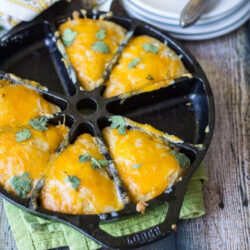 Cheesy Mexican cornbread in a cast iron skillet.