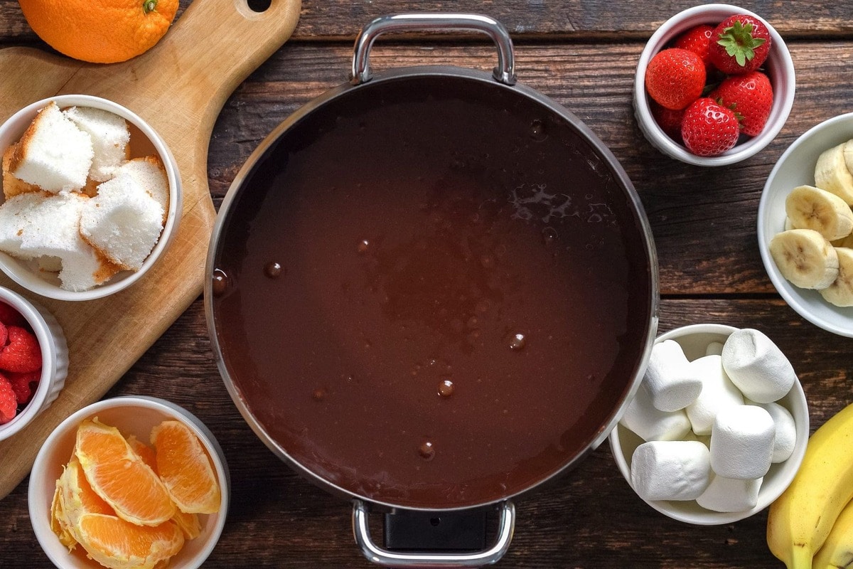 Heating the chocolate in an electric fondue pot until smooth.