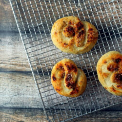 Gourmet soft pretzels cooling on a wire rack.
