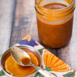 Homemade Colorado sauce in a Mason jar on a table.