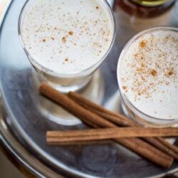 Two homemade eggnogs served on a tray.