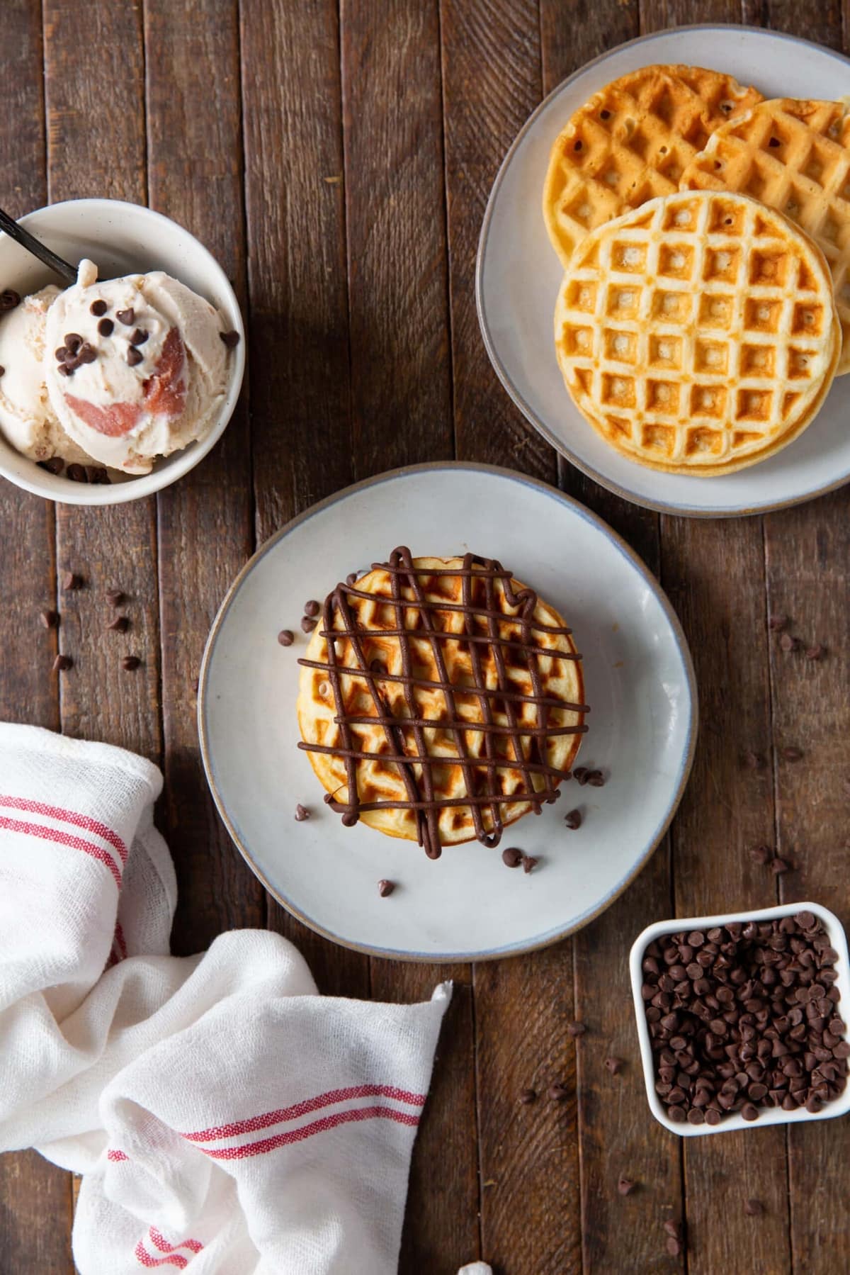Chocolate-covered strawberry waffle drizzled with melted milk chocolate over the top on a plate.