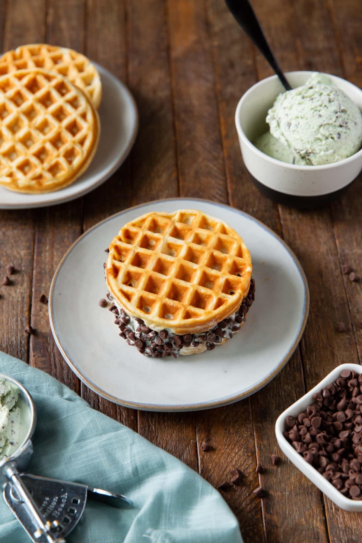 A plate with mint chocolate chip waffle sandwich.