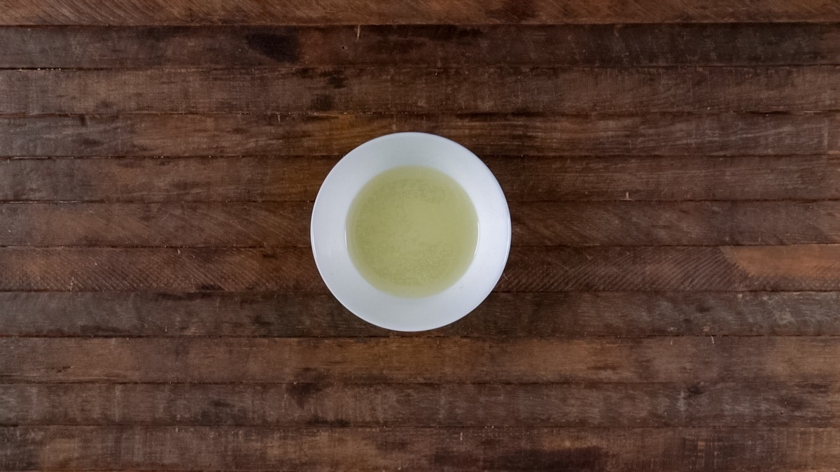 Mango salad dressing mixed in a small bowl.