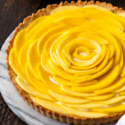 This Mango Tart recipe is truly a work of art. Sweet, creamy and topped with fresh mangoes in the most eye-catching presentation!
