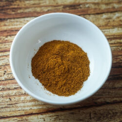 A bowl with Moroccan Spice mix on a table.