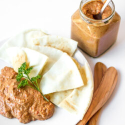 Roasted red pepper dip on a white plate.