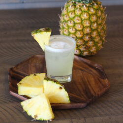 Two glasses with Pineapple Margarita on a table.
