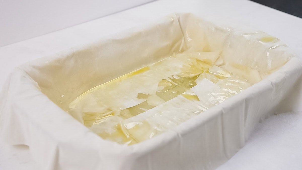 Placing two sheets of phyllo dough on the short ends of the baking dish.