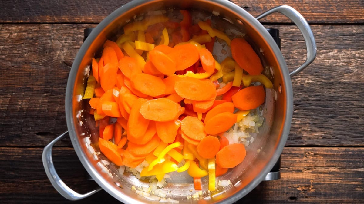 Bell pepper and carrots added to the skillet, along with the other ingredients.