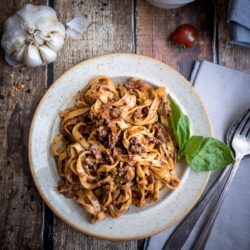 Vegan Bolognese sauce on noodles served on a plate.