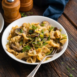 A white bowl with vegan mushroom stroganoff .